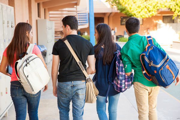 is your child at high risk for substance abuse? - teenagers walking at school - mountain laurel recovery center