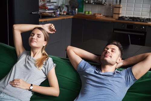 couple relaxing on couch at home