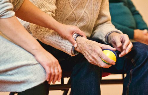 woman helping man at retirement home - volunteering