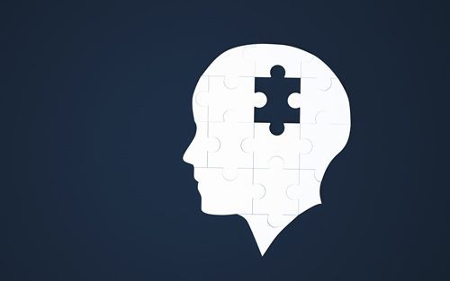 dark blue background with white puzzle in shape of human head - missing piece in middle - blackouts