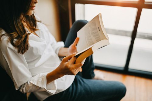 pretty dark haired woman reading a book - memoirs