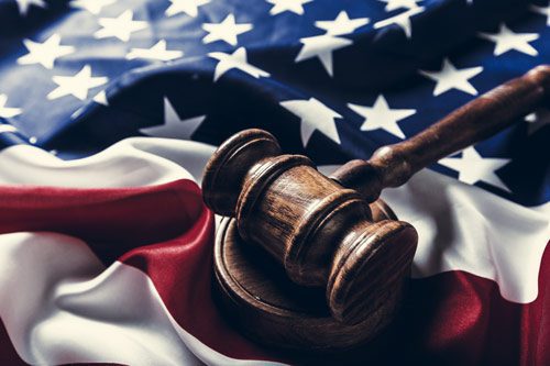 American flag with wooden gavel on it - Veterans Treatment Courts