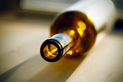 closeup of empty wine or alcohol bottle - tolerance and dependence
